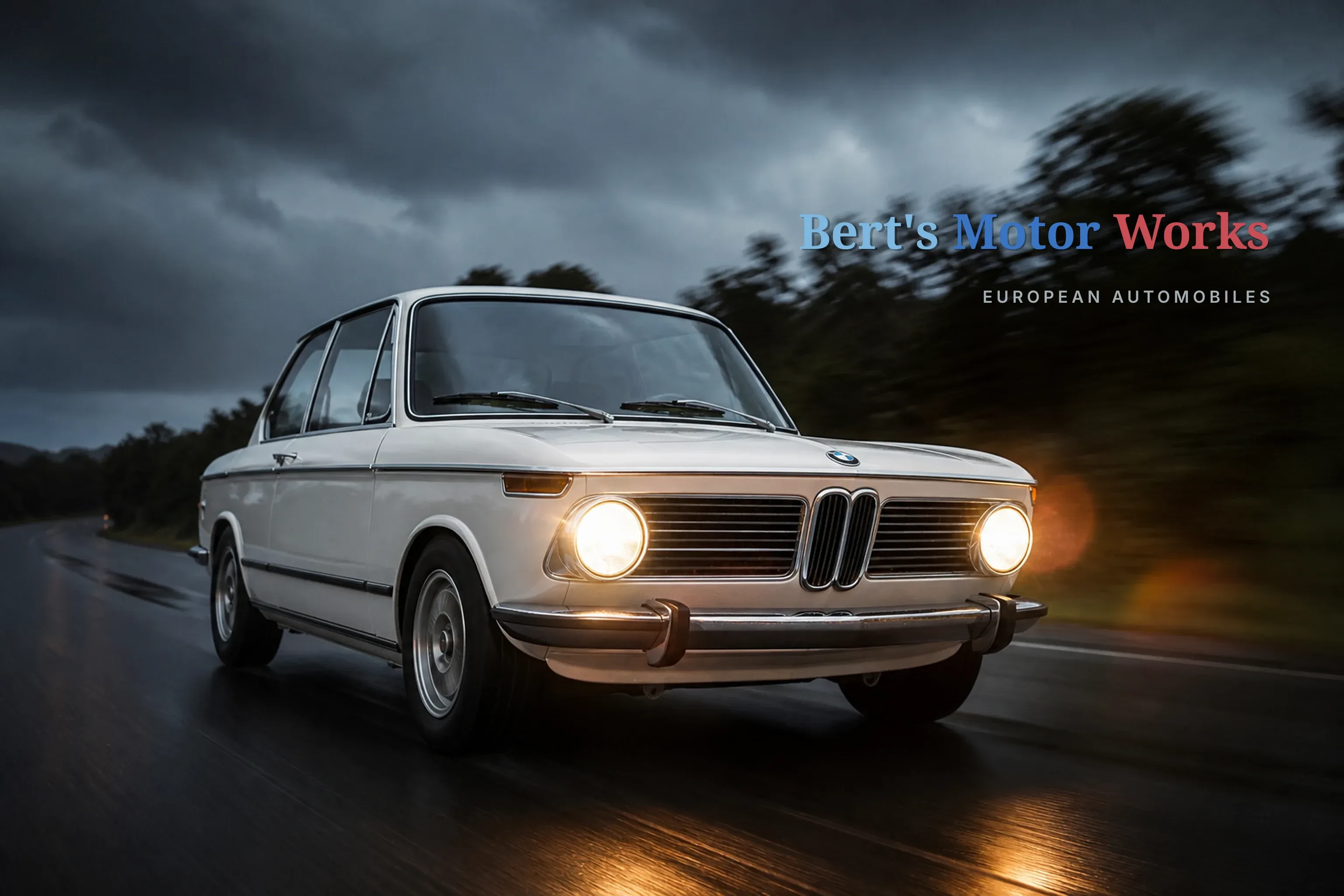 Alpine white BMW 2002 tii on a wet road at dusk